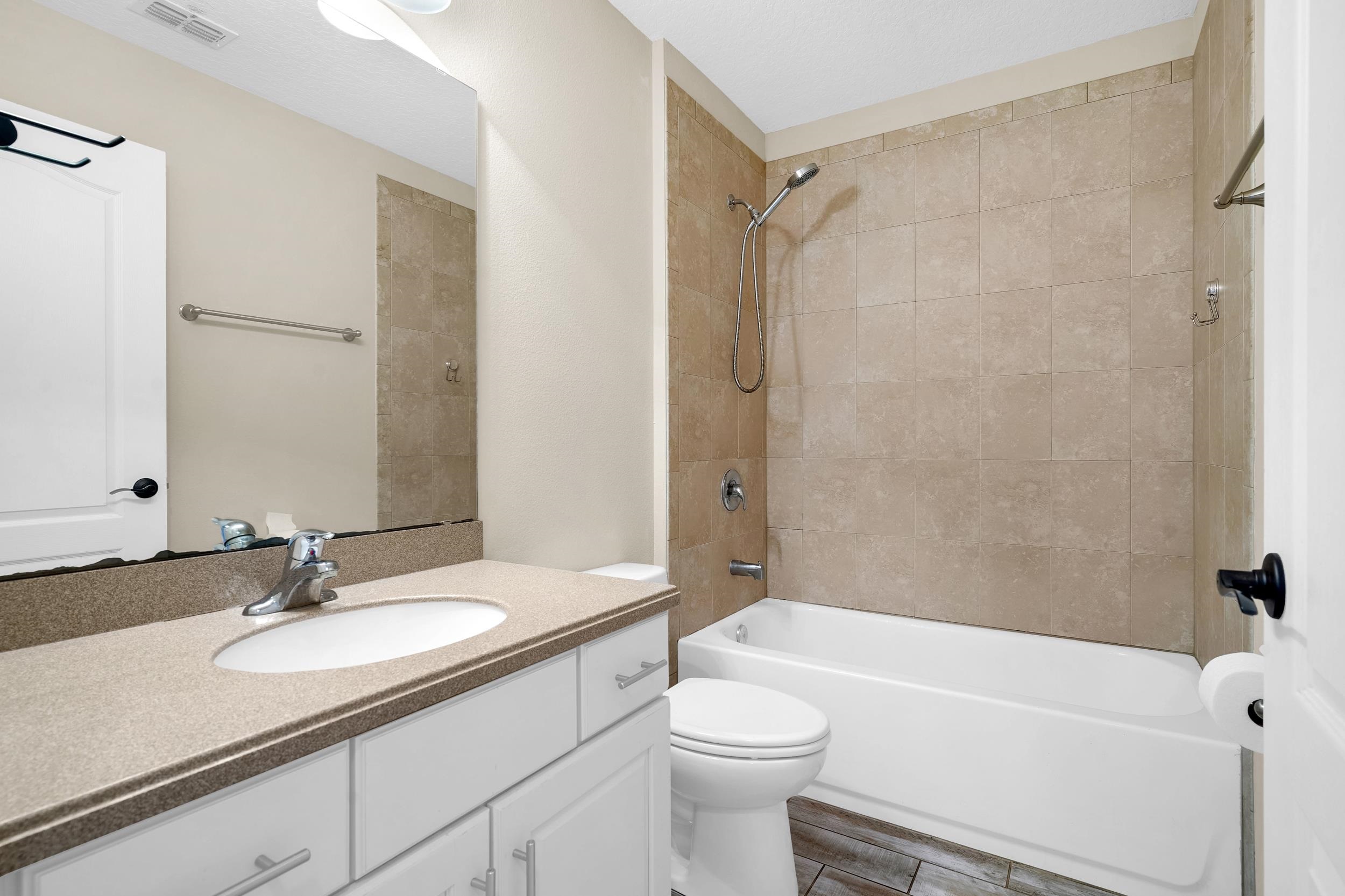 146 Ocean Cay Boulevard St. Augustine, FL 32080 - Photo 29 of 41 a bathroom with a granite countertop sink toilet and shower