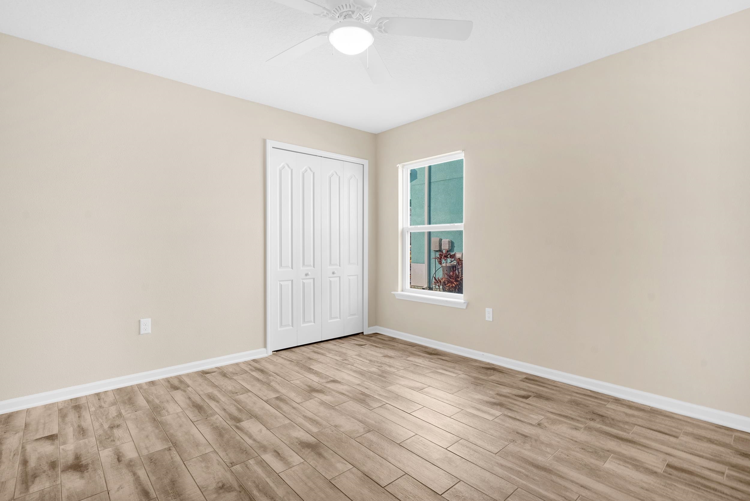 146 Ocean Cay Boulevard St. Augustine, FL 32080 - Photo 30 of 41 an empty room with wooden floor and windows