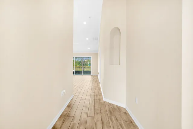a view of a room with wooden floor and a window