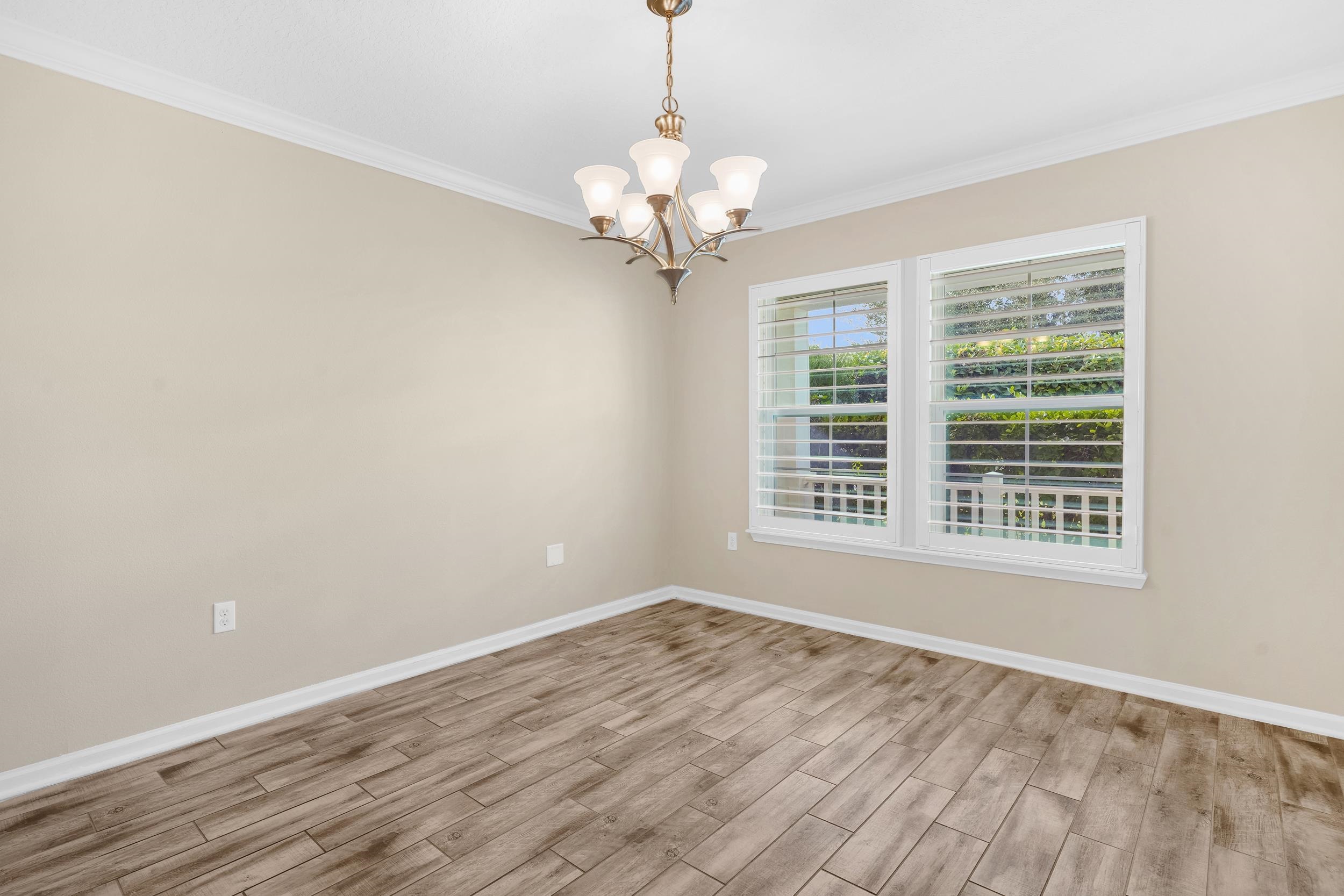 146 Ocean Cay Boulevard St. Augustine, FL 32080 - Photo 10 of 41 a view of a room with wooden floor and chandelier