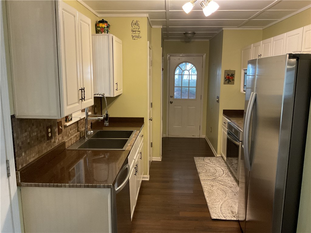 229 Cub Cove Drive Walhalla, SC 29691 - Photo 13 of 50 This functional kitchen features ample counter space, modern appliances, and convenient outdoor access.