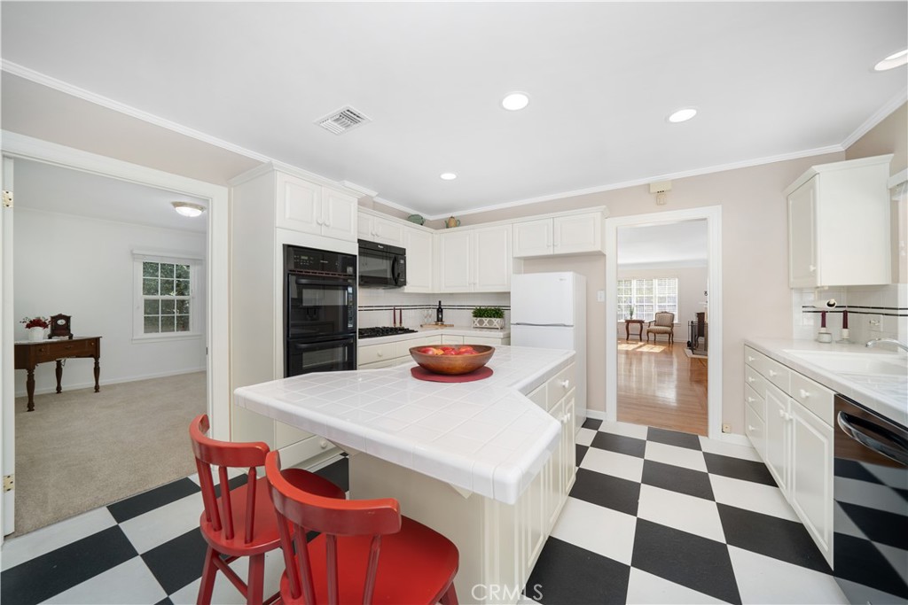 945 Cabrillo Drive Glendale, CA 91207 - Photo 12 of 38 a kitchen with stainless steel appliances kitchen island granite countertop a refrigerator and a sink
