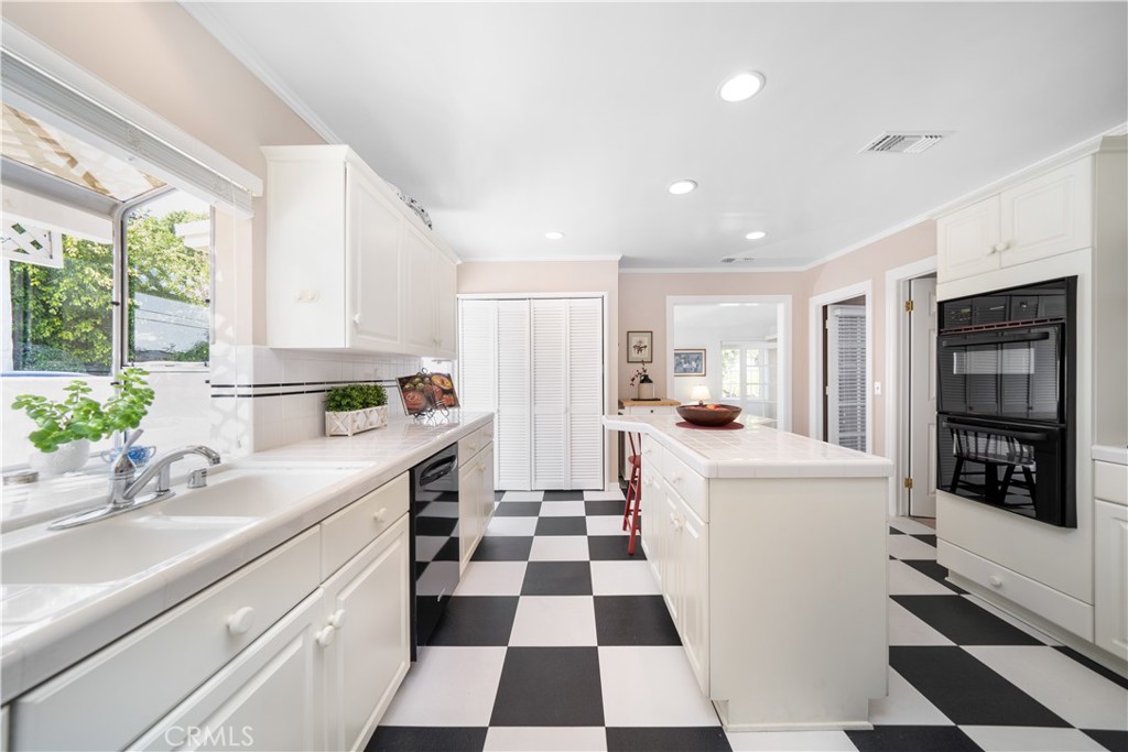 945 Cabrillo Drive Glendale, CA 91207 - Photo 10 of 38 a kitchen with a sink a refrigerator and cabinets