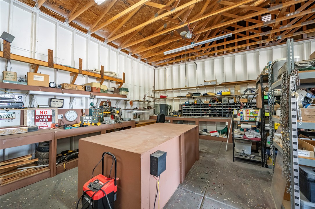 14158 Calabasas Road Yucca, AZ 86438 - Photo 31 of 99 Workshop area with work station and storage shelves