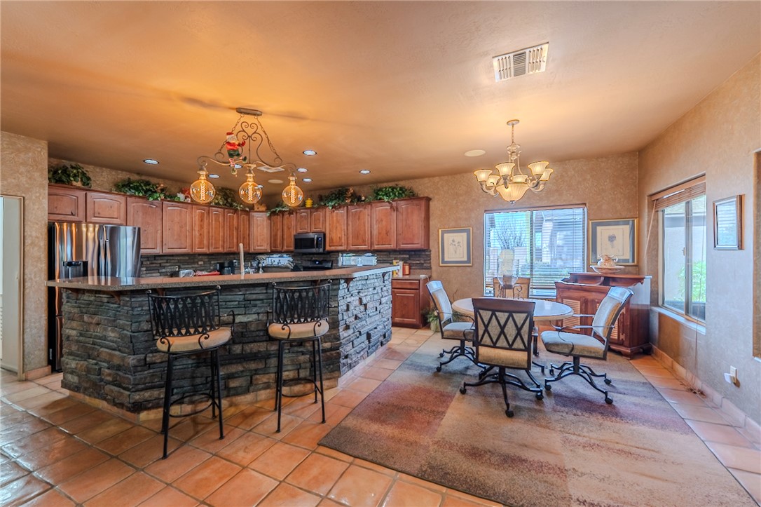 14158 Calabasas Road Yucca, AZ 86438 - Photo 45 of 99 a living room with furniture a chandelier and a dining table