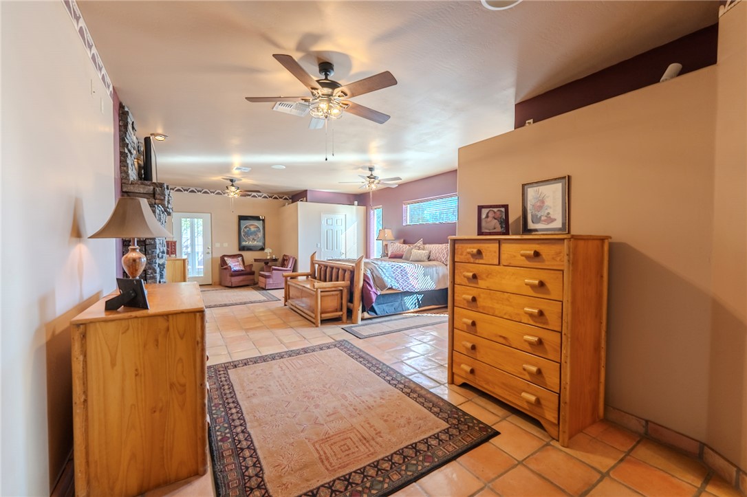 14158 Calabasas Road Yucca, AZ 86438 - Photo 54 of 99 Bedroom featuring light tile patterned flooring and a ceiling fan