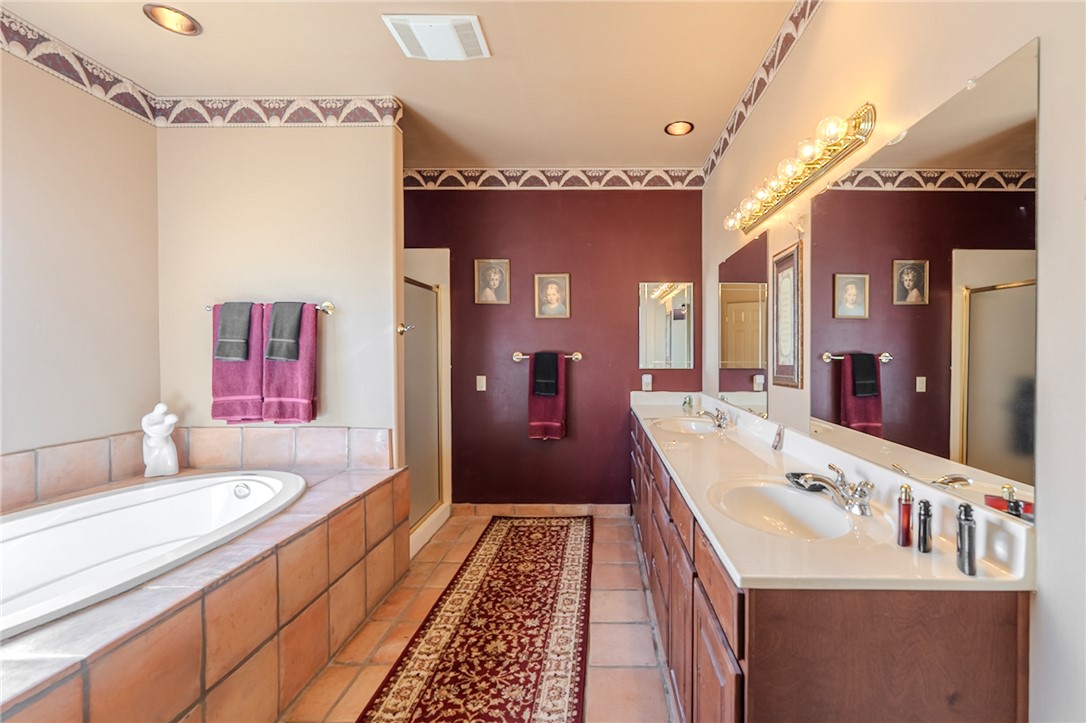 14158 Calabasas Road Yucca, AZ 86438 - Photo 59 of 99 Full bathroom with double vanity, a shower stall, a garden tub, light tile patterned floors, and recessed lighting