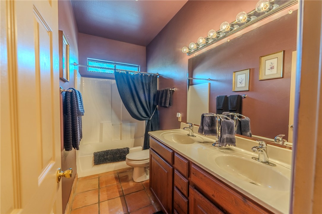 14158 Calabasas Road Yucca, AZ 86438 - Photo 64 of 99 a bathroom with a double vanity sink mirror and toilet