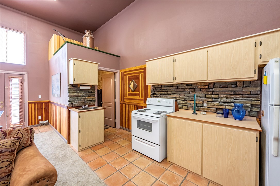 14158 Calabasas Road Yucca, AZ 86438 - Photo 81 of 99 a kitchen with a stove and white cabinets