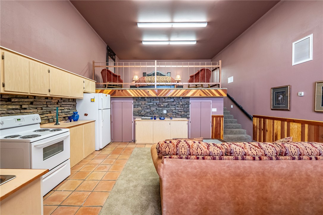 14158 Calabasas Road Yucca, AZ 86438 - Photo 82 of 99 a kitchen with kitchen island granite countertop a stove a sink and a refrigerator