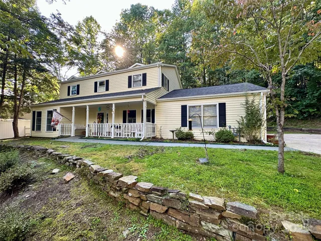 a view of a house with a yard and sitting area