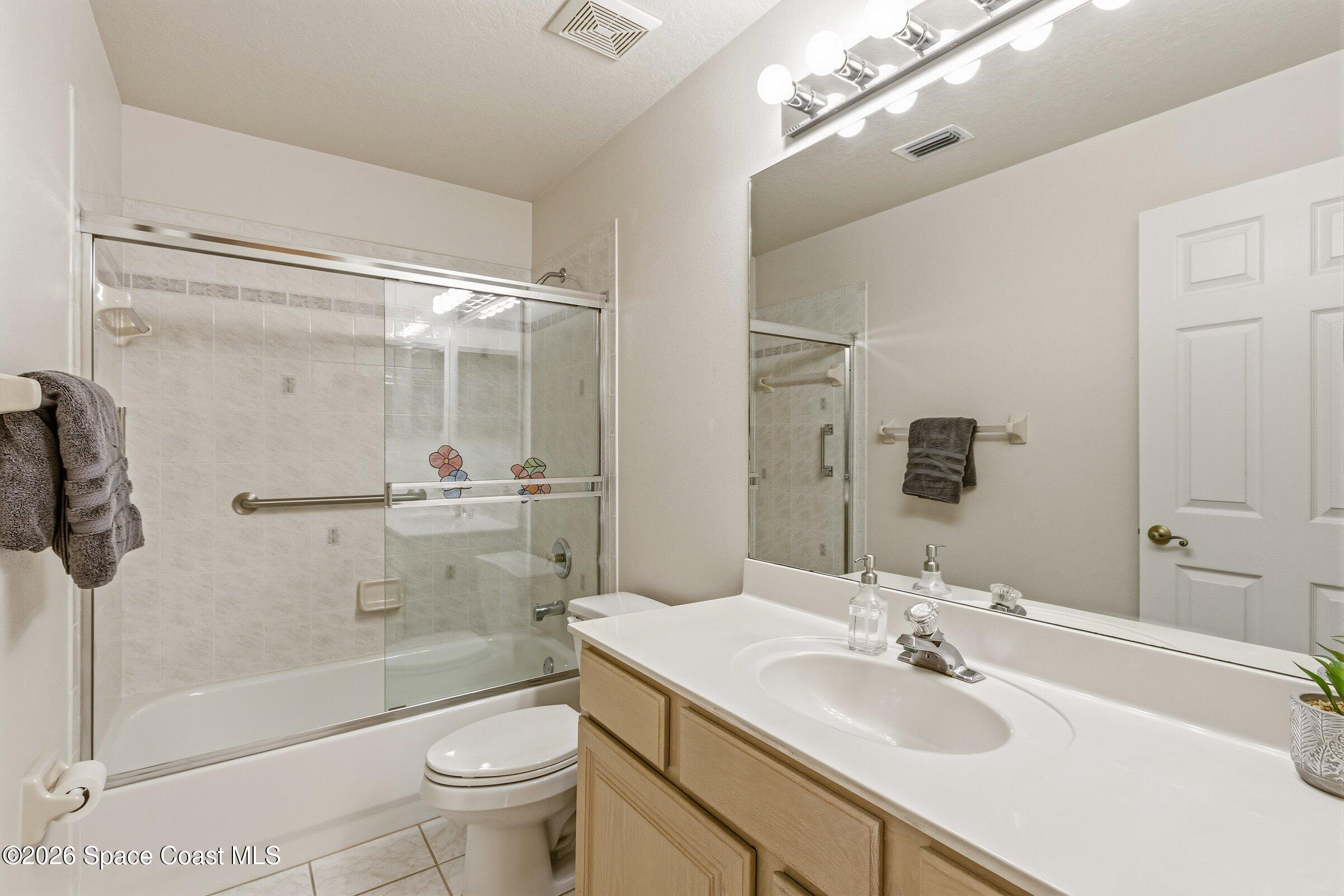 975 South Fork Circle Melbourne, FL 32901 - Photo 14 of 44 a bathroom with a sink a toilet and shower