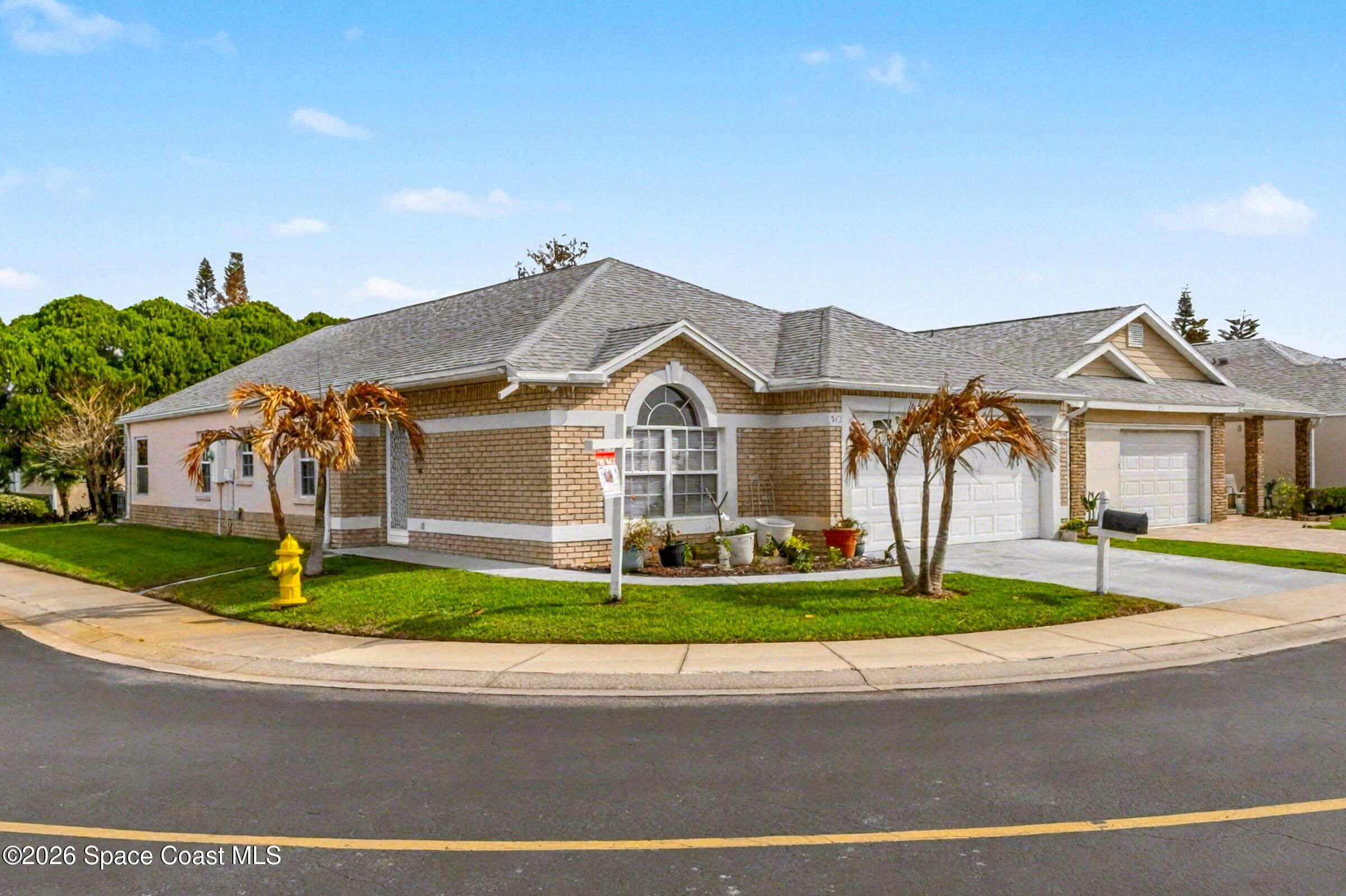 975 South Fork Circle Melbourne, FL 32901 - Photo 2 of 44 a front view of a house with a garden and plants