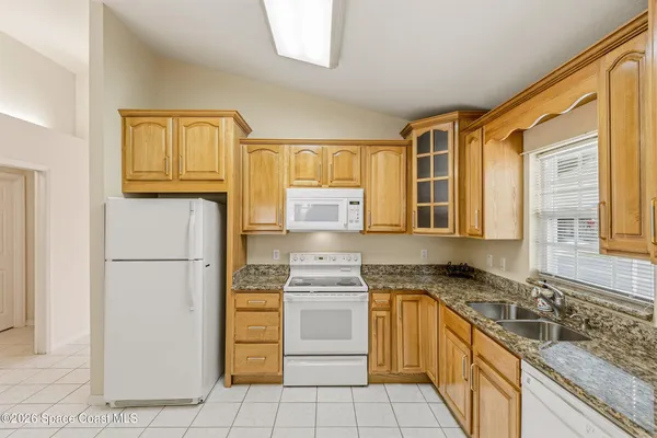 a kitchen with a stove a sink and a refrigerator