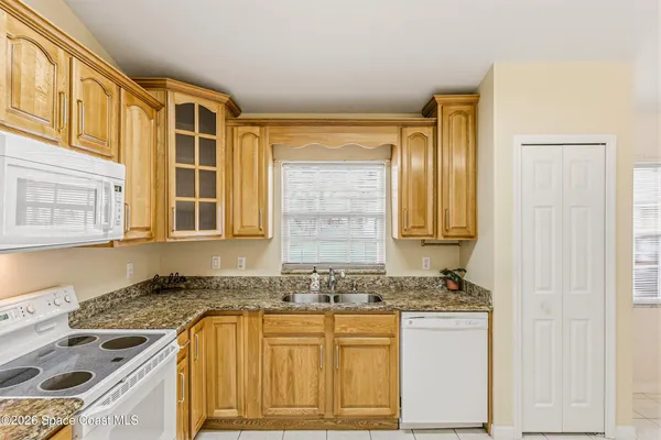 a view of a kitchen with a sink and a refrigerator