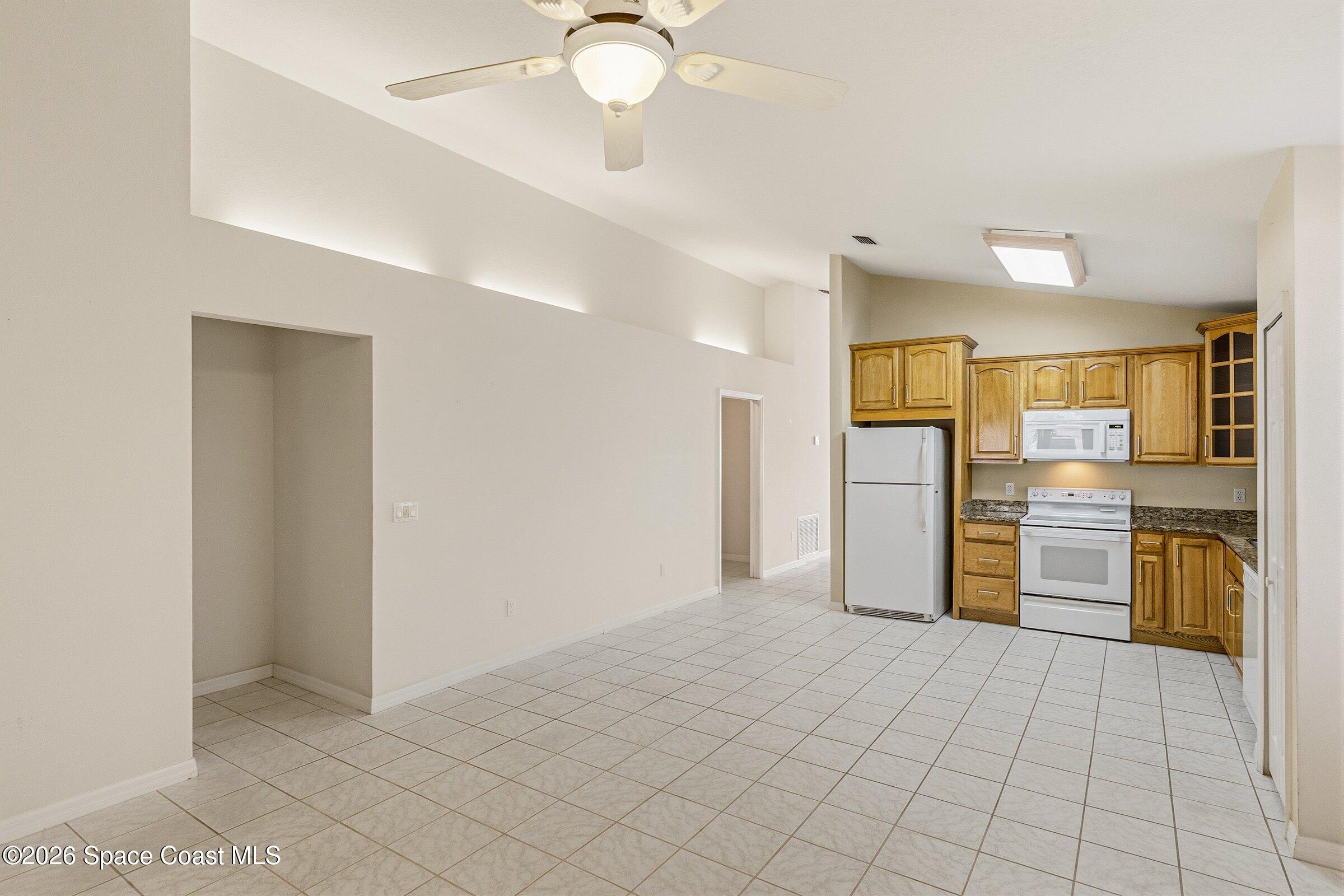 975 South Fork Circle Melbourne, FL 32901 - Photo 10 of 44 a view of a kitchen with a sink and a refrigerator