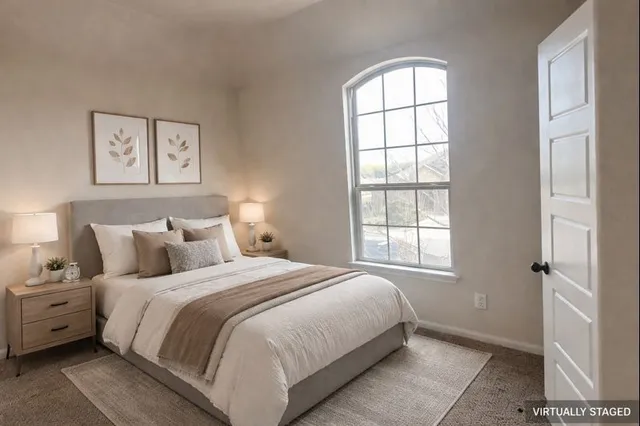 a bedroom with a bed and a window