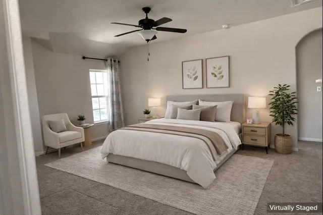 a bedroom with a bed a chandelier and a couch