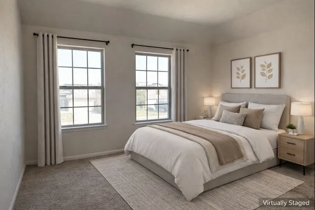 a bed sitting in a bedroom next to a window