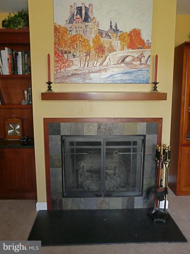 16 Manor Brook Road Monkton, MD 21111 - Photo 14 of 30 a living room with a fireplace and a book shelf