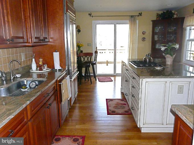 16 Manor Brook Road Monkton, MD 21111 - Photo 25 of 30 a kitchen with stainless steel appliances granite countertop a stove top oven a sink dishwasher and cabinets with wooden floor