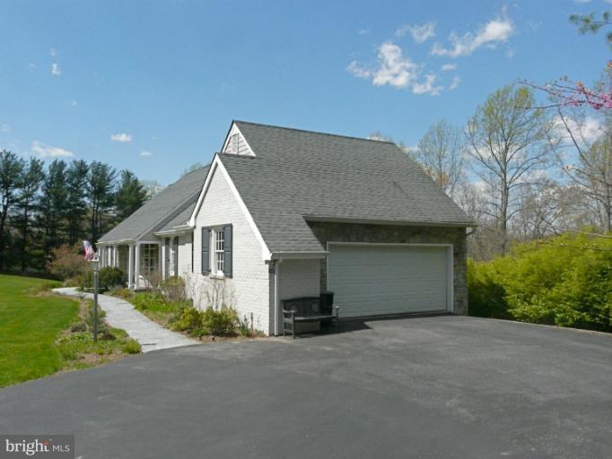 16 Manor Brook Road Monkton, MD 21111 - Photo 10 of 30 a front view of a house with a yard and garage