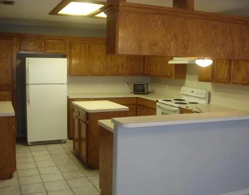 a kitchen with a sink a stove and a refrigerator