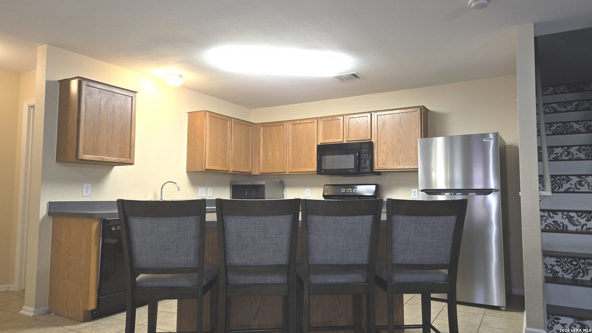 9530 Ascending Converse, TX 78109 - Photo 6 of 15 a kitchen with stainless steel appliances granite countertop a refrigerator a stove top oven a sink and dishwasher