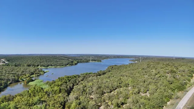 an aerial view of a houses with a lake view