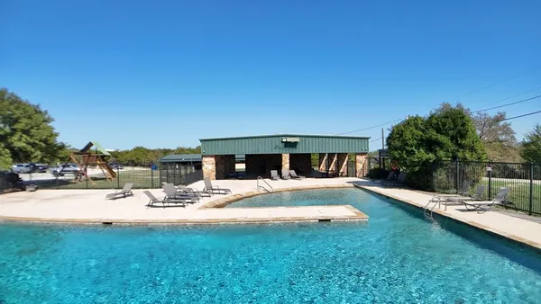 a view of swimming pool with chairs