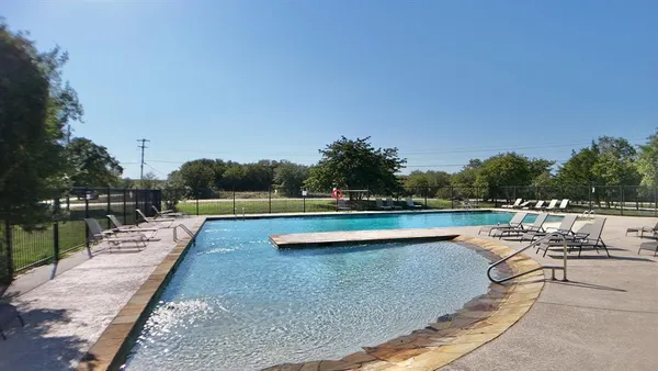 a living room with fireplace furniture and a large window