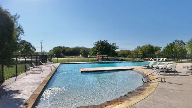 a living room with fireplace furniture and a large window