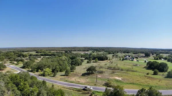 an aerial view of a houses with a yard