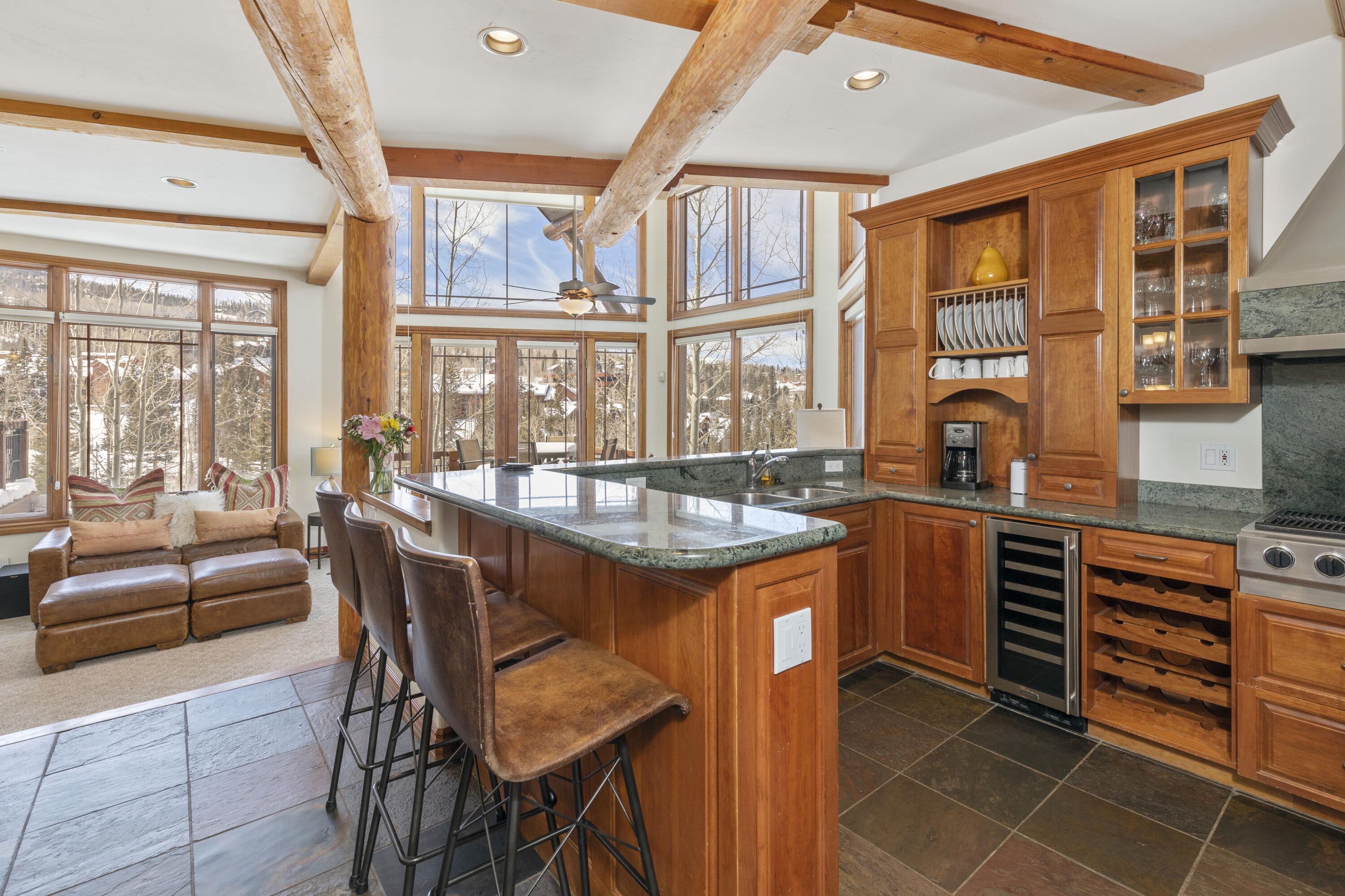 a dining hall with stainless steel appliances granite countertop a stove and a refrigerator