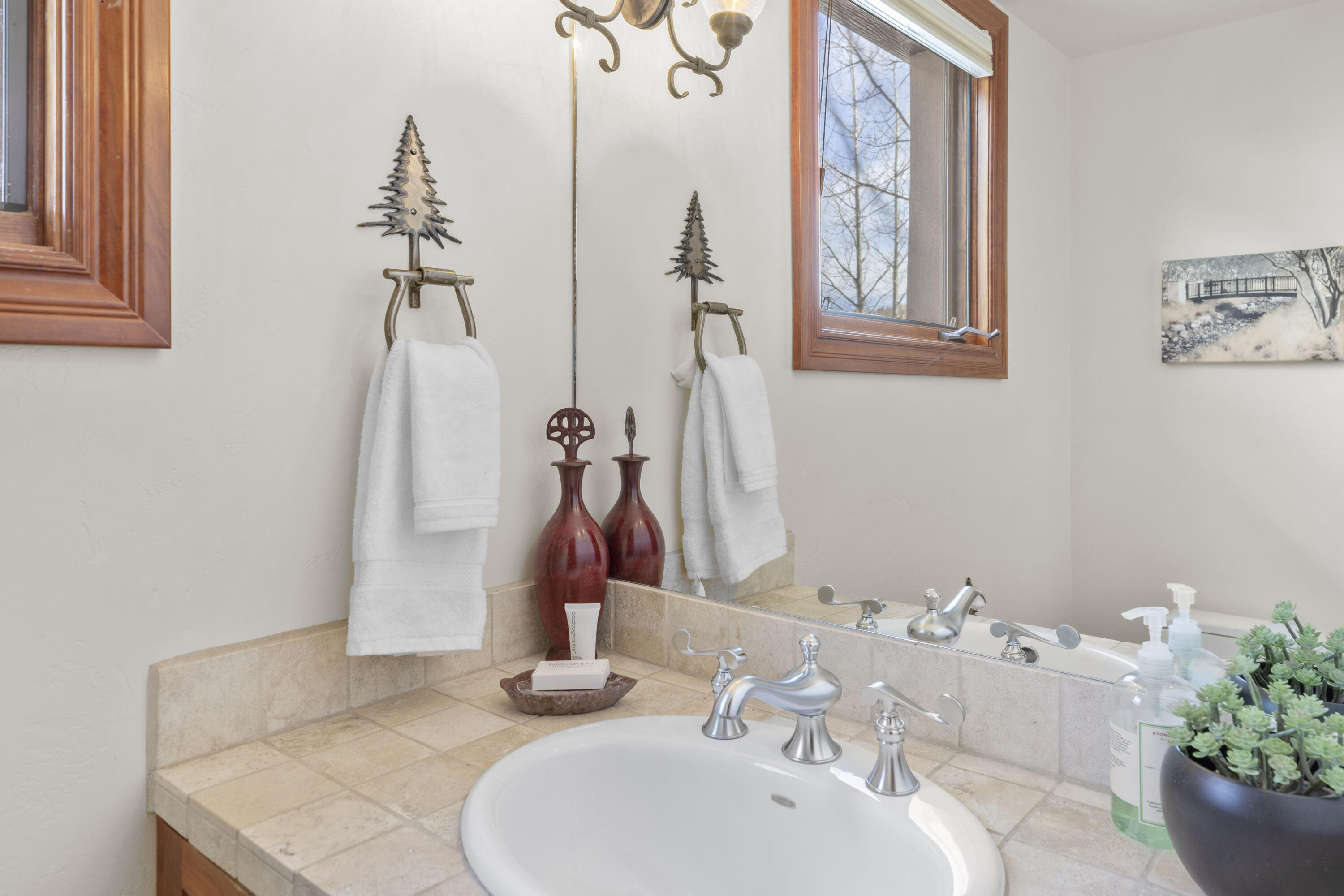 120 Vischer Drive, Unit 135 Mountain Village, CO 81435 - Photo 11 of 35 a bathroom with a granite countertop sink and a mirror