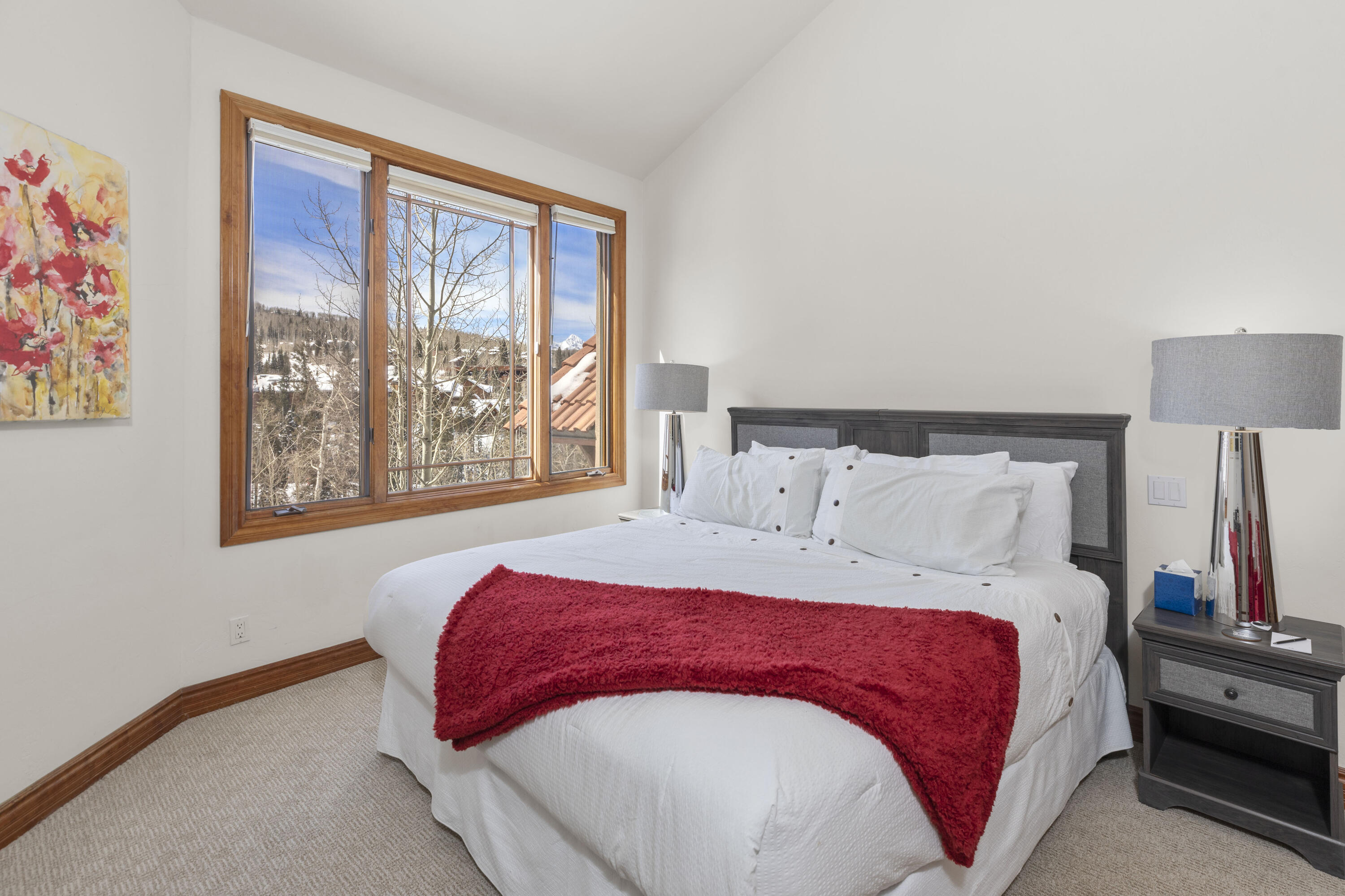 120 Vischer Drive, Unit 135 Mountain Village, CO 81435 - Photo 15 of 35 a bedroom with a large bed and a window