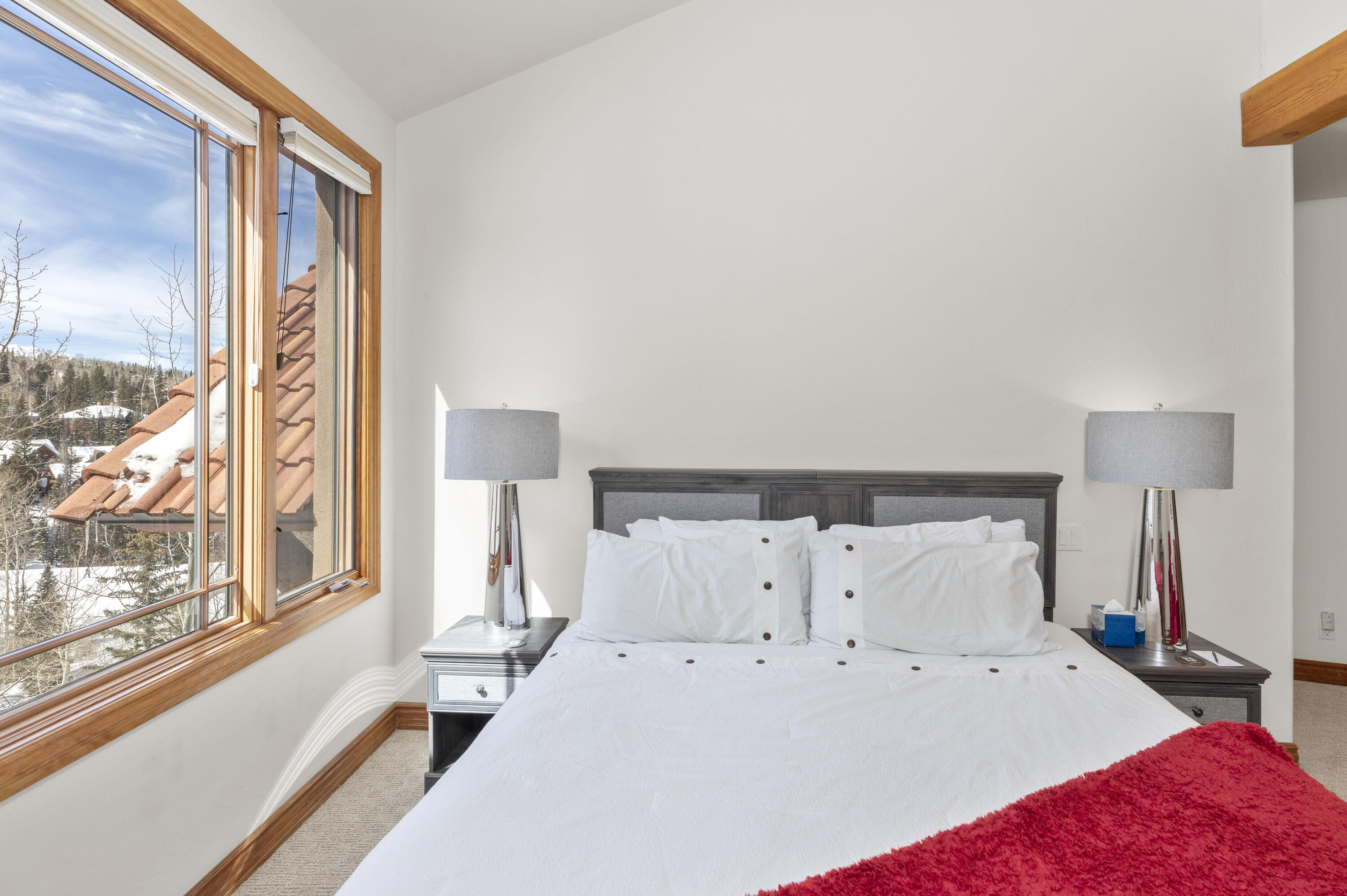 120 Vischer Drive, Unit 135 Mountain Village, CO 81435 - Photo 16 of 35 a large bed sitting in a bedroom next to a window