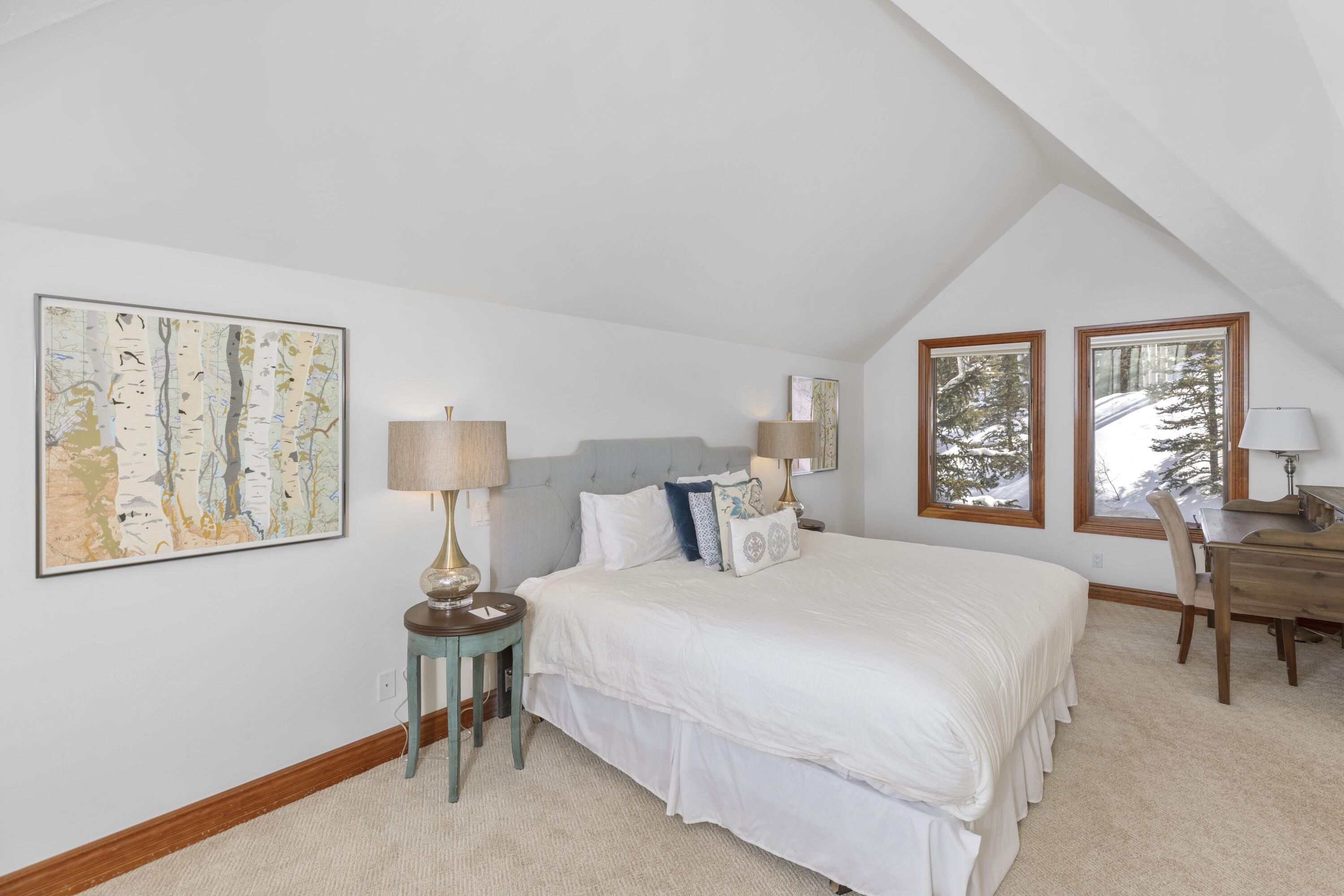 120 Vischer Drive, Unit 135 Mountain Village, CO 81435 - Photo 19 of 35 a bedroom with a bed and a table in it next to a window