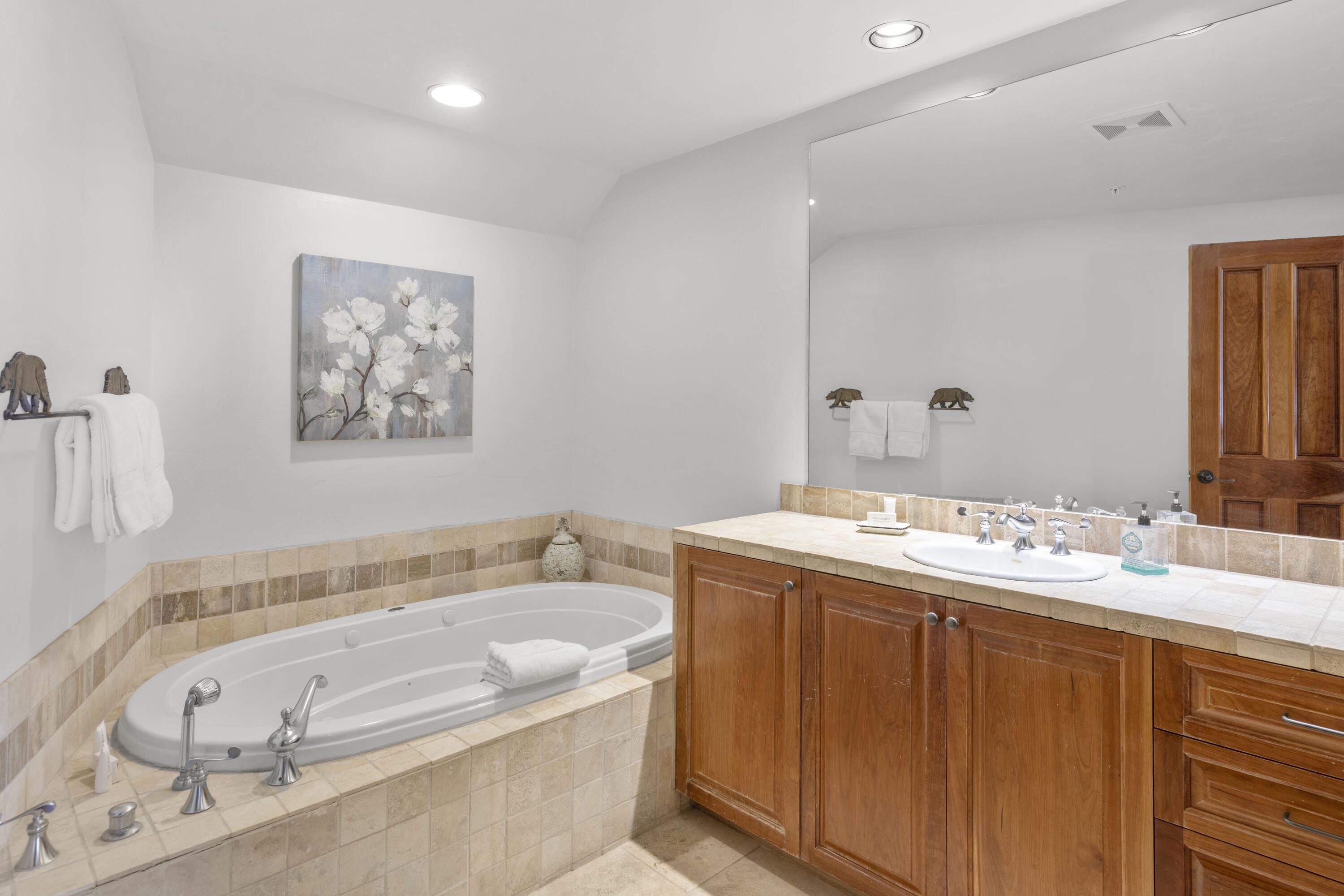 120 Vischer Drive, Unit 135 Mountain Village, CO 81435 - Photo 25 of 35 a bathroom with a tub a sink and mirror
