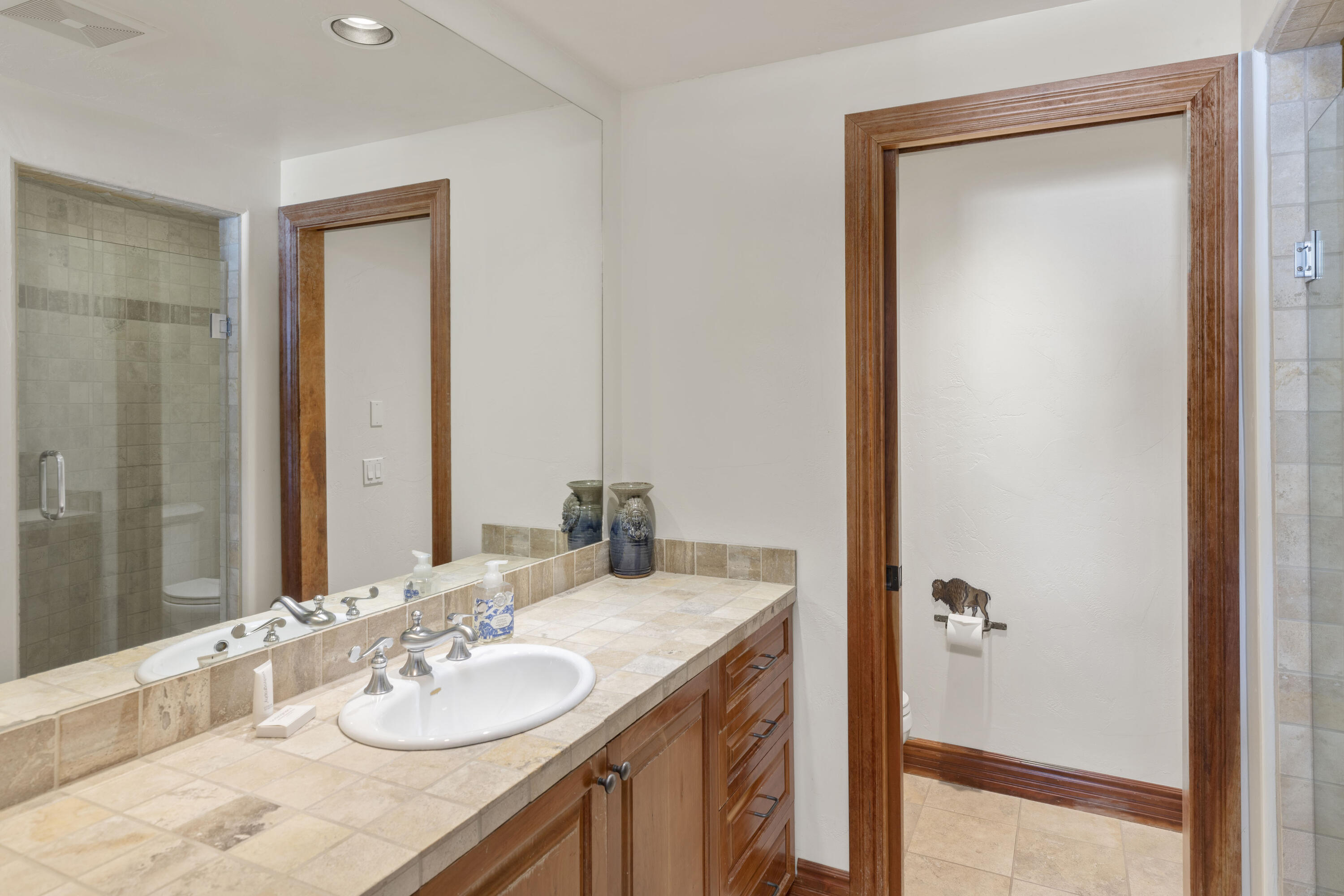 120 Vischer Drive, Unit 135 Mountain Village, CO 81435 - Photo 27 of 35 a bathroom with a granite countertop sink and a mirror