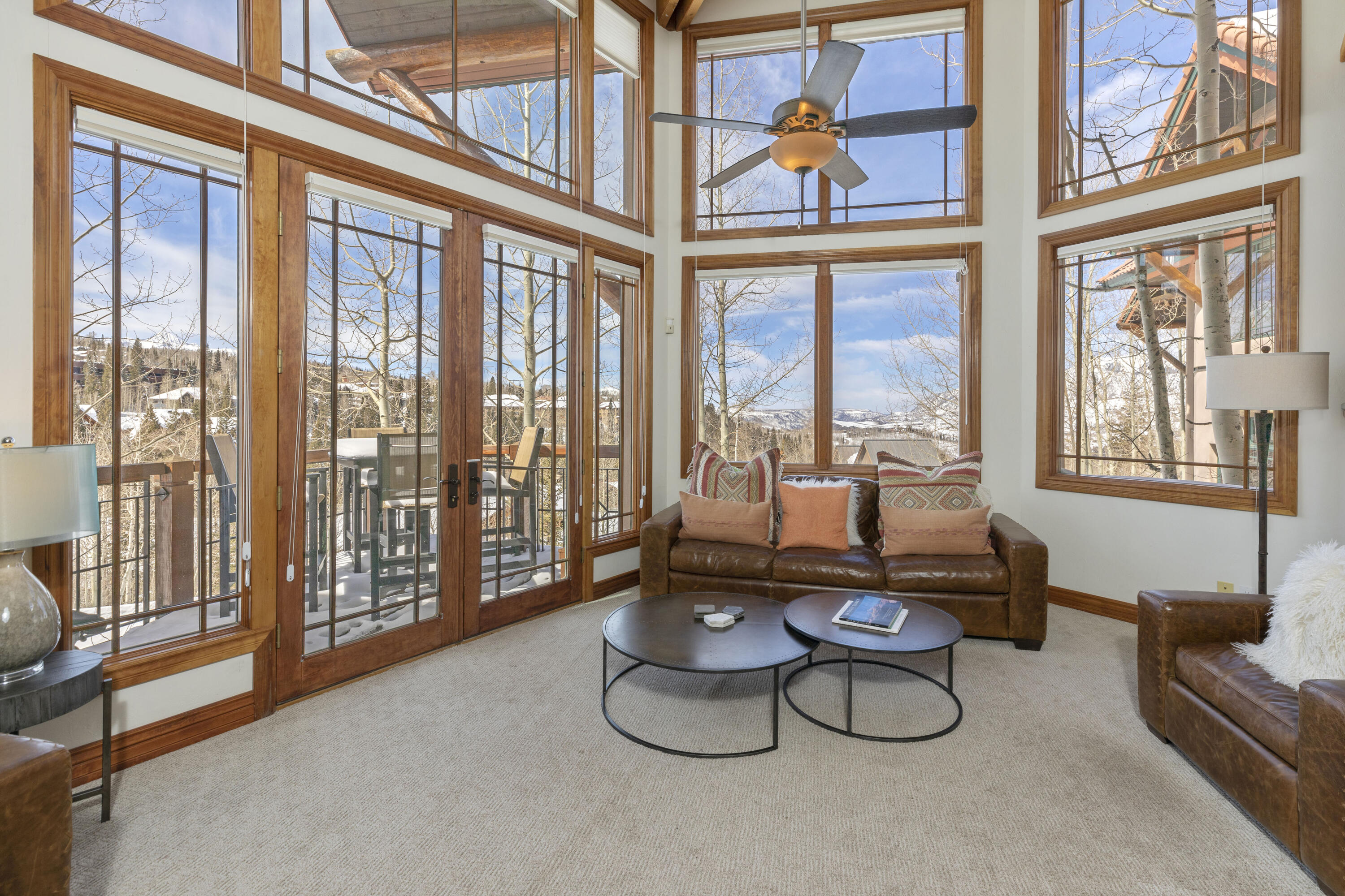 120 Vischer Drive, Unit 135 Mountain Village, CO 81435 - Photo 4 of 35 a living room with furniture and a floor to ceiling window