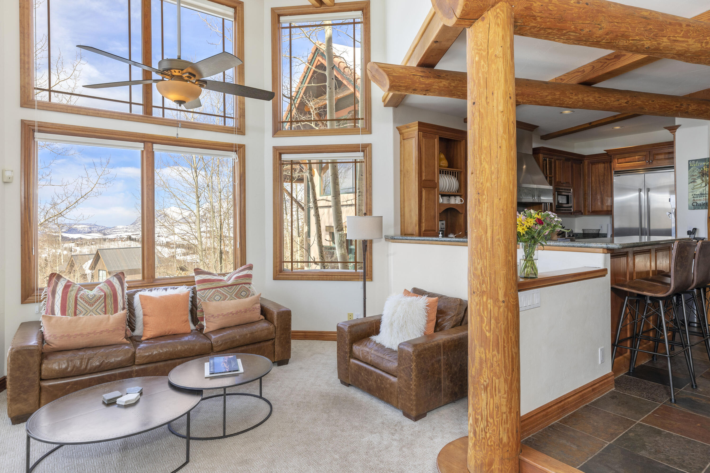 120 Vischer Drive, Unit 135 Mountain Village, CO 81435 - Photo 6 of 35 a living room with furniture a fireplace and large windows