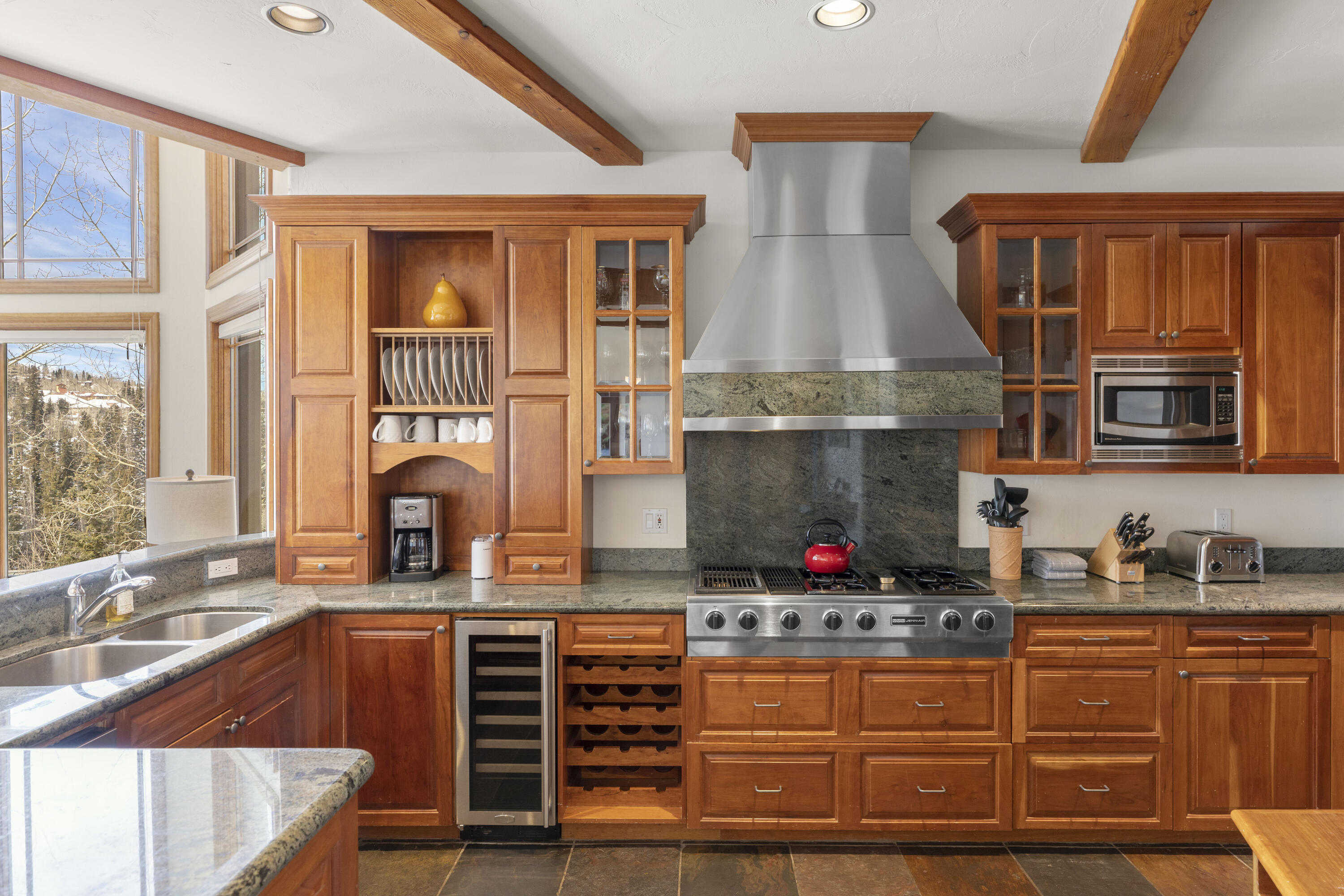 120 Vischer Drive, Unit 135 Mountain Village, CO 81435 - Photo 9 of 35 a kitchen with stainless steel appliances granite countertop a stove and cabinets