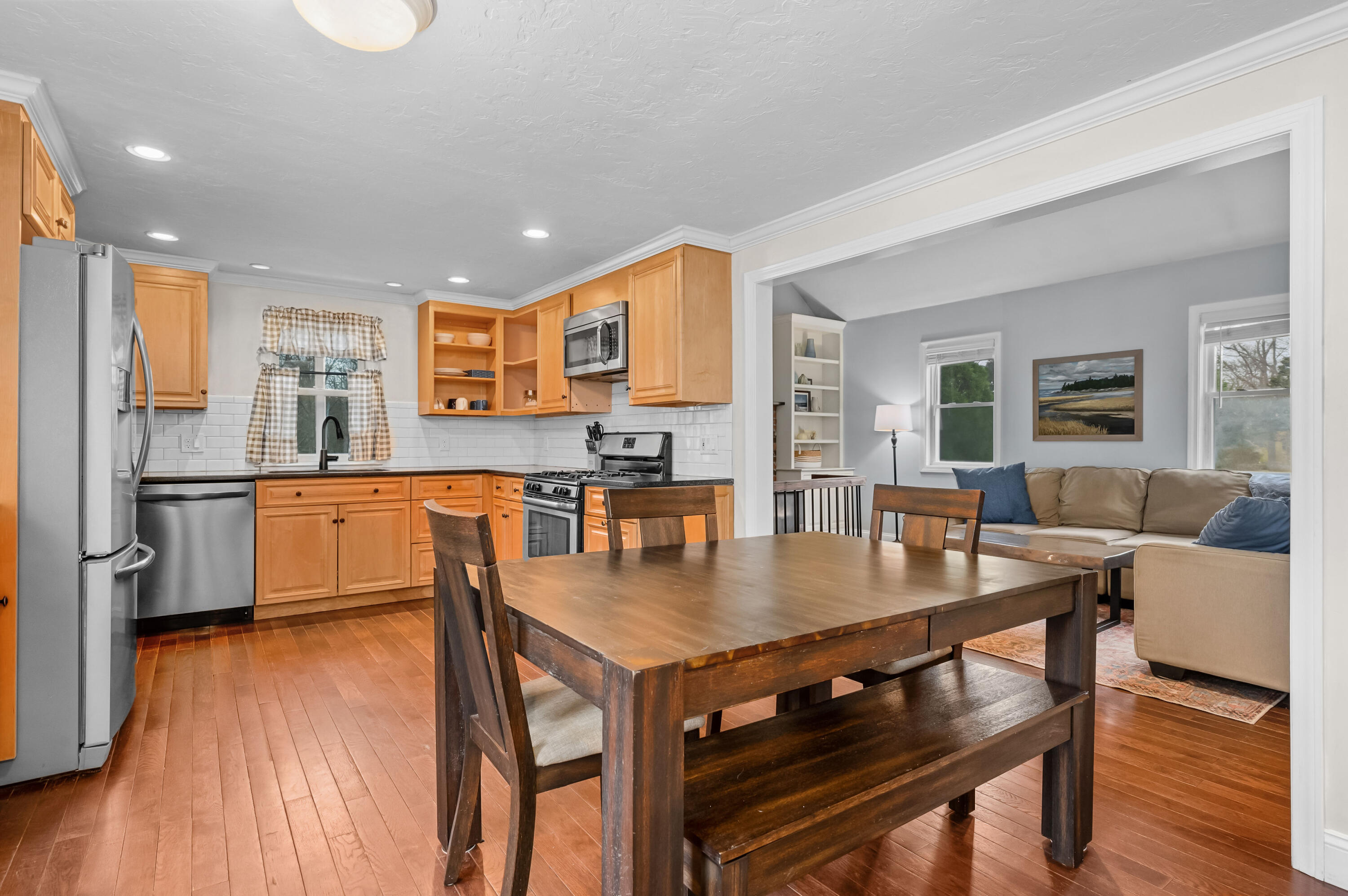 69 Jones Road Marstons Mills, MA 02648 - Photo 7 of 22 a kitchen with a table chairs refrigerator and cabinets