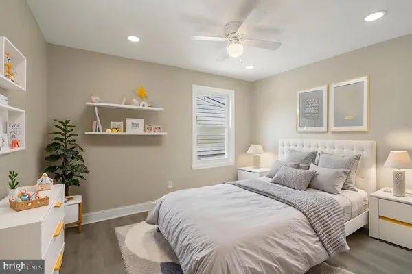 a bedroom with a bed and a potted plant