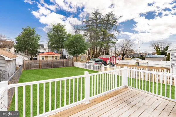 a view of a backyard with a garden and deck
