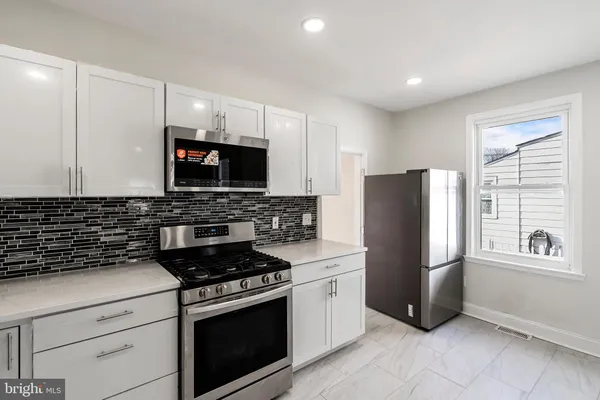 a kitchen with a refrigerator stove and microwave
