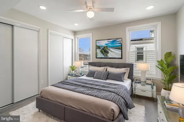 a bedroom with a large bed and a chandelier
