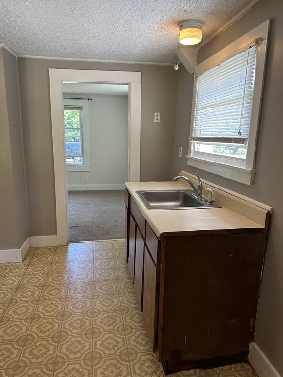 9 West Farms Road Northampton, MA 01062 - Photo 12 of 31 a kitchen with a sink cabinets and window