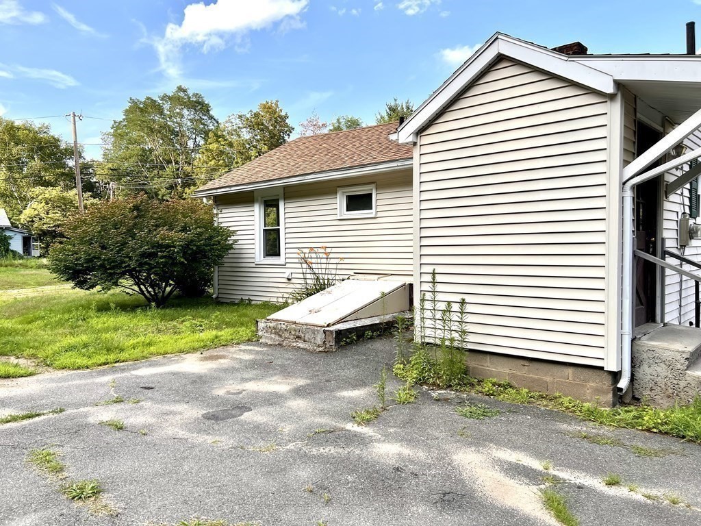 9 West Farms Road Northampton, MA 01062 - Photo 22 of 31 a view of a white house with a yard and a large window